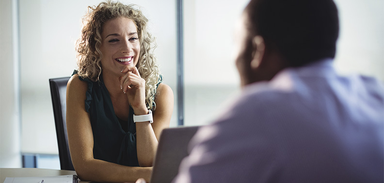 Mulher usando técnicas de persuasão em uma reunião com um cliente.